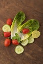 Vegetable: Fresh Green Romaine Lettuce with Baby Tomatoes, Mint Leaves and Cucumber Slices on Brown Wooden Background Royalty Free Stock Photo