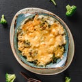 Vegetable Frittata with potato, broccoli, cheese in plate over dark background. Healthy vegan food, clean eating, dieting
