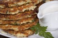 Vegetable fritters of zucchini with parsley and dill closeup . Royalty Free Stock Photo