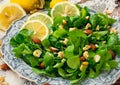 Vegetable green salad with nuts on a wooden board. Royalty Free Stock Photo