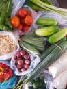 Vegetable groceries in plastic bags on the table