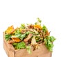 Vegetable kitchen food waste in a re used wooden container for home composting white bacground Royalty Free Stock Photo