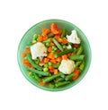 Vegetable mix of carrots, peas, green beans and cauliflower in green plate, close-up view from above isolated on white background Royalty Free Stock Photo