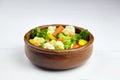 Vegetable mix. Vegan food. Boiled broccoli, cauliflower and carrot in wooden bowl on white table. Healthy food. Steamed vegetables Royalty Free Stock Photo