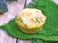 Vegetable muffin with broccoli, carrot, egg and cheese on green cloth on wooden background