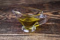 Olive oil in a glass gravy boat. vegetable oil on a black background. Royalty Free Stock Photo