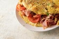 Vegetable omelette filled with tomatoes, prosciutto ham and pars