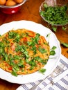 Vegetable omelette with pea shoots microgreens on white plate