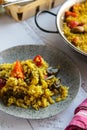 Vegetable paella in a frying pan and on a plate close-up Royalty Free Stock Photo