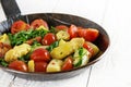 Vegetable pan with fried asparagus, tomatoes and spinarch on a w Royalty Free Stock Photo