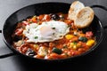 Vegetable pisto manchego with tomatoes, zucchini, peppers, onions,eggplant and egg, served in frying pan