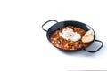 Vegetable pisto manchego with tomatoes, zucchini, peppers, onions,eggplant and egg, served in frying pan isolated on white