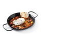 Vegetable pisto manchego with tomatoes, zucchini, peppers, onions,eggplant and egg, served in frying pan isolated on white