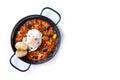 Vegetable pisto manchego with tomatoes, zucchini, peppers, onions,eggplant and egg, served in frying pan isolated on white