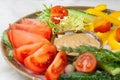 vegetable plate of fresh tomatoes peppers cherry tomatoes and cucumbers with sauce. vegetarian dish Royalty Free Stock Photo