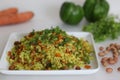 Vegetable Poha is a quick breakfast or snack made of beaten rice or flattened rice along peanuts, carrots and chilies Royalty Free Stock Photo