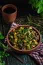 Vegetable roast eggplant and potatoes in a clay plate ketsa. Homemade healthy food in a rustic style