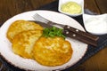 Vegetable rosti, golden fried potato pancakes with dips from cauliflower and sour cream