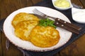 Vegetable rosti, golden fried potato pancakes with dips from cauliflower and sour cream