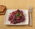 Vegetable salad of beets, onions, beans on a plate with slices of rye bread Royalty Free Stock Photo