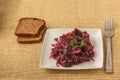 Vegetable salad of beets, onions, beans on a plate with slices of rye bread Royalty Free Stock Photo