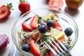 SVegetable salad with berries, close-up, against the background of strawberries, fork on a Cup Royalty Free Stock Photo