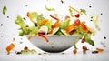 Vegetable salad in a bowl with flying ingredients and drops of olive oil Royalty Free Stock Photo