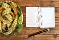Vegetable salad with centimeter and empty notepad Royalty Free Stock Photo
