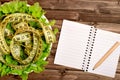 Vegetable salad with centimeter and notepad Royalty Free Stock Photo