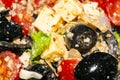 Vegetable salad with cheese. Fitness salad with tomatoes, onions, olives, lettuce and cheese. Surface texture. Close up Royalty Free Stock Photo