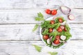 Vegetable salad with cucumber, cherry tomatoes, radish and fresh arugula, Healthy natural breakfast with lemon, detox diet concept Royalty Free Stock Photo