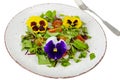 Vegetable salad with edible flowers on white background Royalty Free Stock Photo