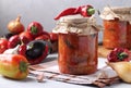 Vegetable salad with eggplant, carrot, peppers, onion and tomatoes in glass jars. Royalty Free Stock Photo