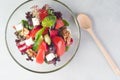 Vegetable salad with feta cheese in a glass dish