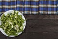 Vegetable salad with fresh vegetables and arugula on a wooden table. Salad with green fresh vegetables in a glass bowl. Vegetarian Royalty Free Stock Photo