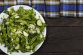 Vegetable salad with fresh vegetables and arugula on a wooden table. Salad with green fresh vegetables in a glass bowl. Vegetarian Royalty Free Stock Photo