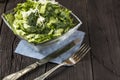 Vegetable salad with fresh vegetables on a wooden table. Salad with green fresh vegetables in a glass bowl. Vegetarian food salad. Royalty Free Stock Photo