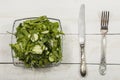 Vegetable salad with fresh vegetables on a wooden table. Salad with green fresh vegetables in a glass bowl. Vegetarian food salad. Royalty Free Stock Photo