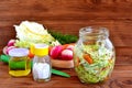 Vegetable salad in glass jar. Easy mixed vegetable salad recipe. Salad with cabbage, carrots, radish, dill and olive oil Royalty Free Stock Photo
