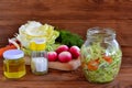 Vegetable salad in glass jar. Simple mixed vegetable salad. Salad with cabbage, carrots, radish, dill and olive oil Royalty Free Stock Photo