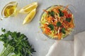 Vegetable salad of grated cabbage and carrots with lemon and olive oil dressing garnished with parsley on a gray Royalty Free Stock Photo