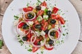 Vegetable Salad. Gray plate. Wooden light background. Free space for text. Salad of cucumbers, tomato and cabbage. Royalty Free Stock Photo