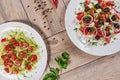 Vegetable Salad. Gray plate. Wooden light background. Free space for text. Salad of cucumbers, tomato and cabbage. Royalty Free Stock Photo