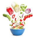 Vegetable salad in levitation. Fresh vegetarian salad of cucumbers, cabbage, cherry tomatoes, onions, peppers, spinach