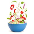 Vegetable salad in levitation. Fresh vegetarian salad of cucumbers, cabbage, cherry tomatoes, onions, peppers, spinach