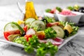 Vegetable salad and Olive oil in a bottle. Fresh chopped vegetables in a salad bowl. Healthy eating. Vegetarian food Royalty Free Stock Photo