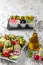 Vegetable salad and Olive oil in a bottle. Fresh chopped vegetables in a salad bowl. Healthy eating. Vegetarian food Royalty Free Stock Photo