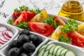 Vegetable salad and Olive oil in a bottle. Fresh chopped vegetables in a salad bowl. Healthy eating. Vegetarian food Royalty Free Stock Photo