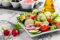 Vegetable salad and Olive oil in a bottle. Fresh chopped vegetables in a salad bowl. Healthy eating. Vegetarian food Royalty Free Stock Photo
