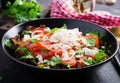 Vegetable salad with tomato, fresh lettuce, soft cheese and onion. Royalty Free Stock Photo